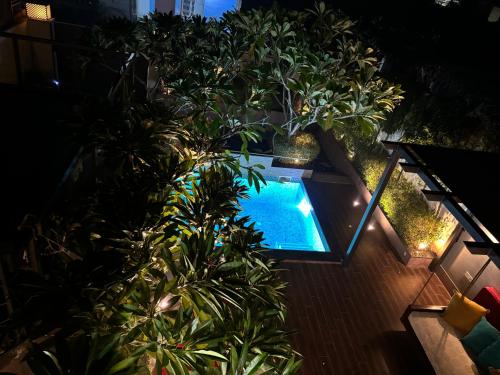 an overhead view of a swimming pool with trees and lights at Lumbini in Varanasi
