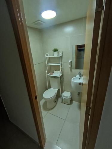 a small bathroom with a toilet and a sink at Vista Colonial, en el Residencial Riviera Colonial in Calero