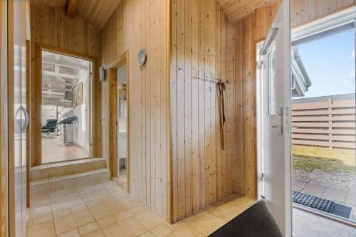 a room with wood paneled walls and a large window at 84252-Ronde-Folfodvej-16 in Rønde