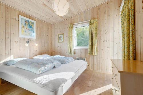 a bedroom with a large white bed in a room at 84266-Knebel-Toplaerkevej-1 in Knebel