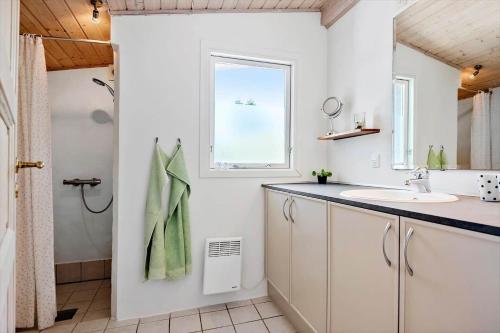 a bathroom with a sink and a window at 30383-Odder-Lyngbakkevej-10 in Odder