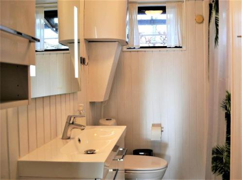 a small bathroom with a sink and a toilet at 30512-Odder-Hasselvaenget-9 in Odder