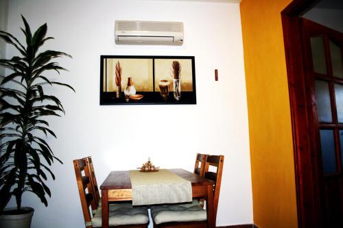 a dining room with a table and a plant at AIDA Apartman in Gyula