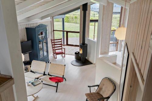 a view of a living room with chairs and a stove at 30430-Odder-Strandvaenget-15 in Odder
