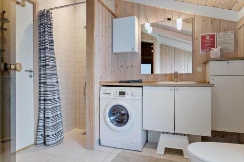 a bathroom with a washing machine and a sink at 30430-Odder-Strandvaenget-15 in Odder