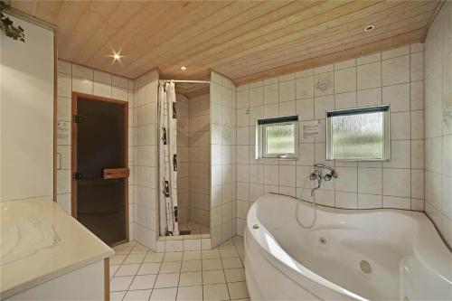 a large bathroom with a tub and a shower at 30410-Odder-Hulager-2 in Odder