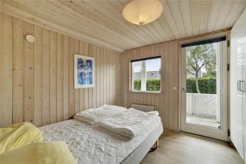a bedroom with a bed and a large window at 30410-Odder-Hulager-2 in Odder