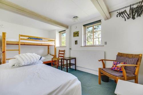 a bedroom with a bed and a desk and chairs at 30580-Odder-Grindsnabevej-31 in Odder