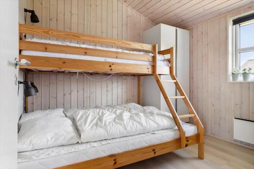 a bunk bed in a room with a ladder at 30451-Odder-Strandvaenget-7 in Odder