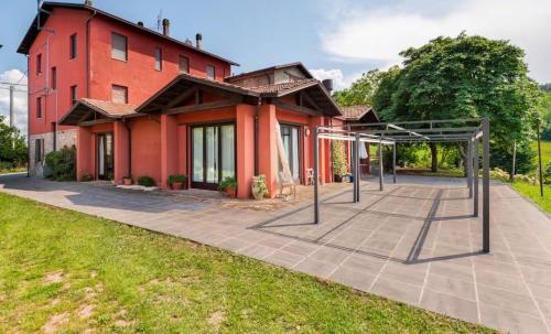 a red house with a basketball hoop in front of it at Mountain Farmhouse Between Parma And Cinque Terre in Solignano