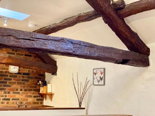 a room with wooden beams on the ceiling at Rebecca Puddle Duck Cottage in Bassenthwaite