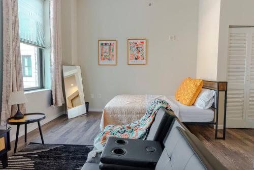 a bedroom with a bed with a tv on it at The City Escape| Studio Apt w/ Skyline Views in Cincinnati