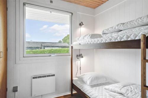 a bedroom with two bunk beds and a window at 30457-Odder-Snekkeager-20 in Odder