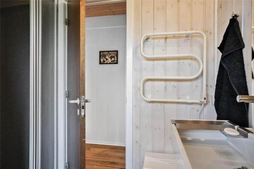 a bathroom with a sink and a towel rack at 30457-Odder-Snekkeager-20 in Odder
