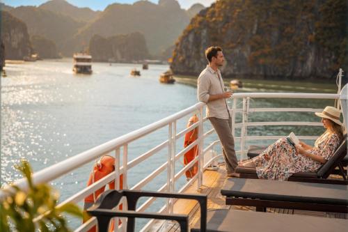 a man and a woman standing on the deck of a boat at Beka Travel Cruise in Cat Ba