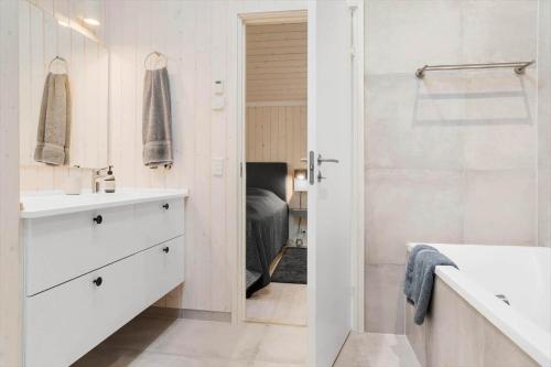 a white bathroom with a sink and a shower at 30319-Odder-Grindevej-19 in Odder