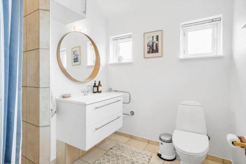 a white bathroom with a sink and a mirror at 40155-Juelsminde-Bugten-31 in Juelsminde