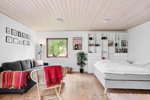 a living room with a bed and a couch at 30725-Odder-Skovgardsparken-87 in Odder