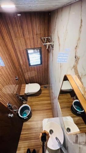 a bathroom with a sink and two toilets at Hotel U Life Residency Mumbai in Mumbai