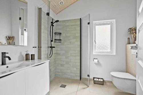 a white bathroom with a shower and a toilet at 30465-Odder-Stakket-Torn-9 in Odder