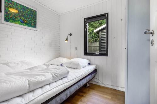 a white room with a bed and a window at 30355-Odder-Granvej-14 in Odder