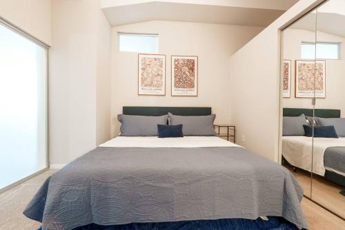 a bedroom with a large bed and a mirror at 2 BHK Unit In Core Downtown Cincy in Cincinnati