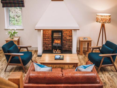 a living room with a couch and a fireplace at An Dobhran - Ukc5752 in Dornie