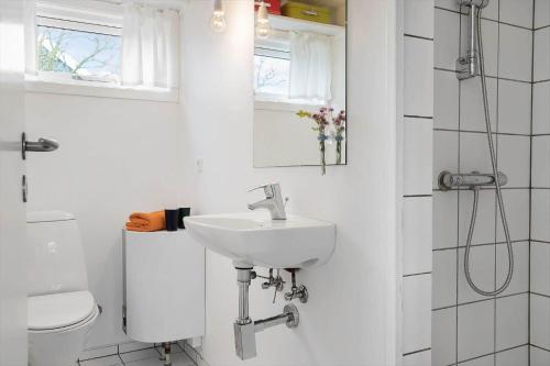a white bathroom with a sink and a toilet at 40161-Juelsminde-Bugten-30 in Juelsminde