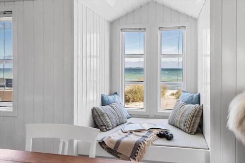 a room with a window seat with a view of the ocean at 30594-Odder-Toldvejen-45-H in Odder