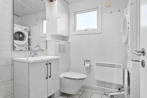 a white bathroom with a toilet and a sink at 30461-Odder-Hulager-6 in Odder