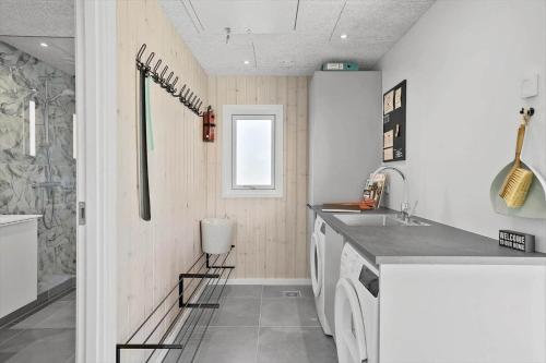 a kitchen with a sink and a washing machine at 30484-Odder-Strandvaenget-60 in Odder