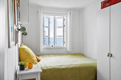 a small bedroom with a bed and a window at 30553-Odder-Toldvejen-45-F in Odder