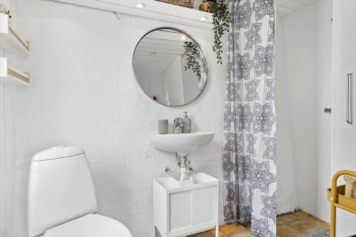 a white bathroom with a sink and a mirror at 30553-Odder-Toldvejen-45-F in Odder
