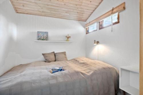 a bedroom with a bed in a white room at 30401-Odder-Stakket-Torn-12 in Odder