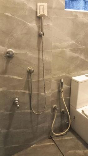 a bathroom with a shower and a toilet at Ahangama Wave Nook in Ahangama