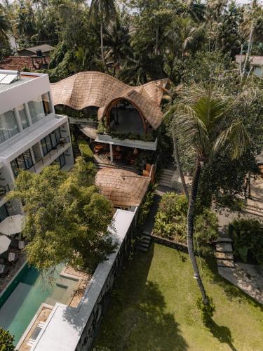 an aerial view of a building and a palm tree at Terra Resort in Ahangama