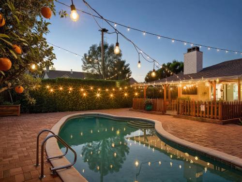a swimming pool with lights and a house at Private Pool Retreat Near Disney Game Room Firepit in Fullerton