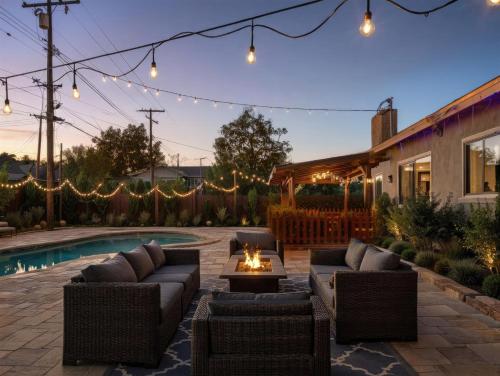 a backyard patio with couches and a fire pit at Private Pool Retreat Near Disney Game Room Firepit in Fullerton