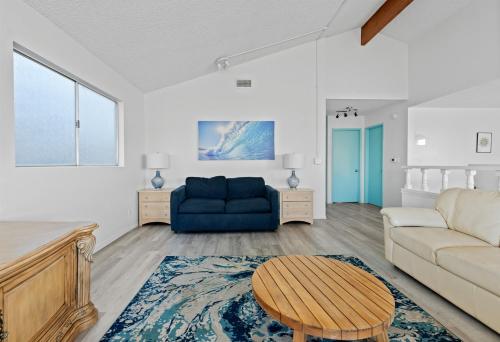 a living room with a blue couch and a table at Ocean View Beach Stay w Pool Table & Bikes in Oxnard