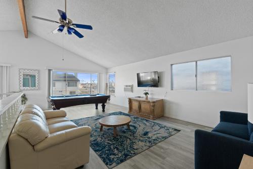 a living room with a couch and a pool table at Ocean View Beach Stay w Pool Table & Bikes in Oxnard