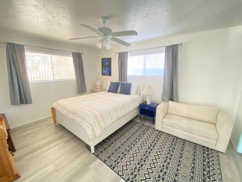 a bedroom with a bed and a chair and a ceiling fan at Sea View, Boards, Bikes, Wd in Oxnard