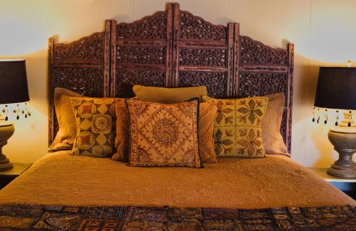 a bedroom with a large bed with two lamps at Edwoods Boutique Bed & Breakfast in Oamaru