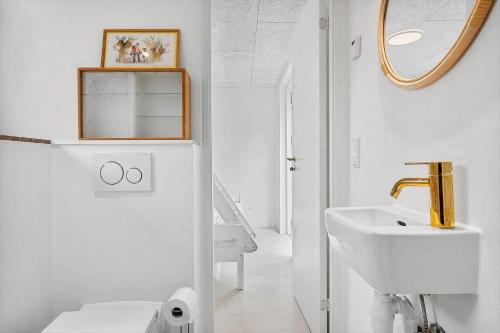 a white bathroom with a sink and a mirror at 40160-Juelsminde-Hasselvej-8 in Juelsminde