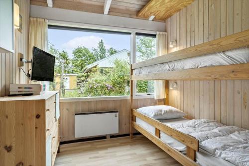 a bedroom with two bunk beds and a window at 30536-Odder-Strandagervej-3 in Odder