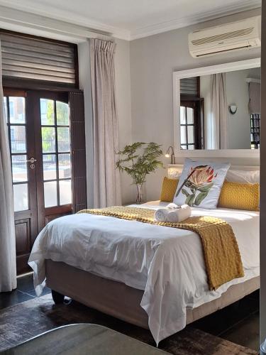 a bedroom with a large bed with a large mirror at Studio in Central Stellenbosch in Stellenbosch