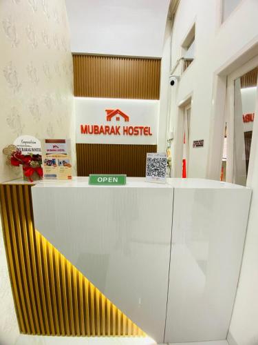a lobby of a muzak hotel with a sign at Mubarak Hostel Syari'ah in Bukittinggi