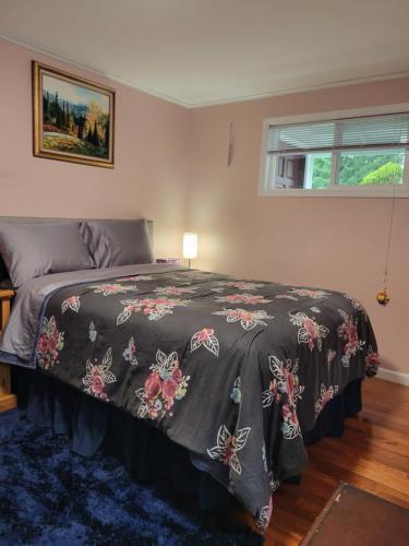 a bedroom with a bed with a bedspread with butterflies on it at Nice and cozy in Bremerton
