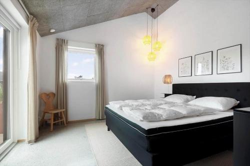 a bedroom with a large bed and a window at 30477-Odder-Strandvaenget-2 in Odder