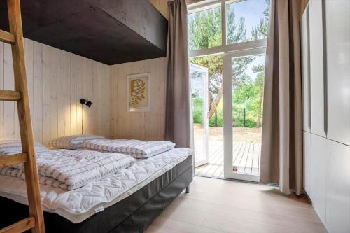 a bedroom with two bunk beds and a large window at 30356-Odder-Hougaardsvej-36 in Odder