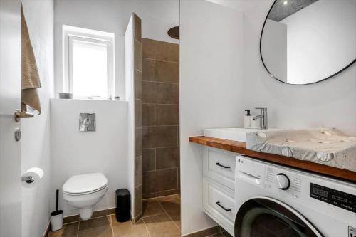 a bathroom with a sink and a washing machine at 30356-Odder-Hougaardsvej-36 in Odder